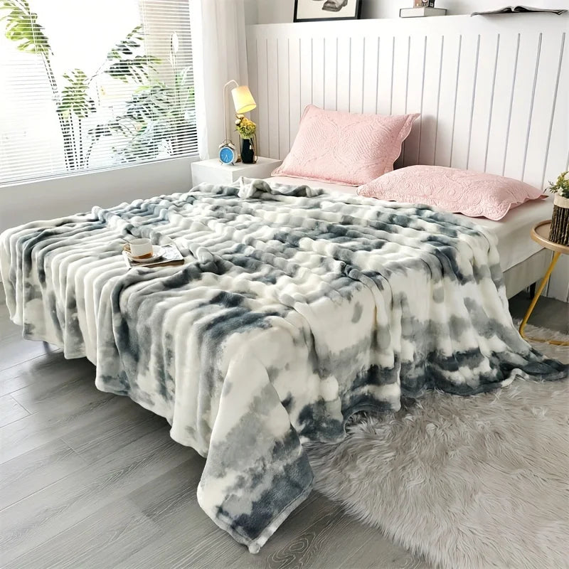 Slate Swirl faux rabbit fur throw on a bed