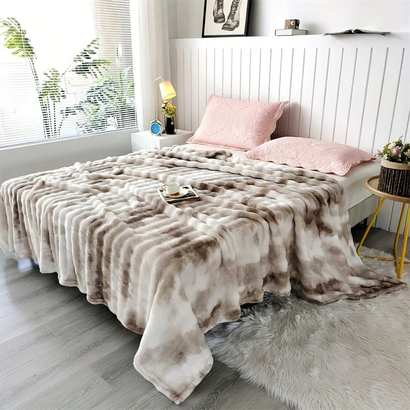 Taupe Swirl faux rabbit fur throw on a bed