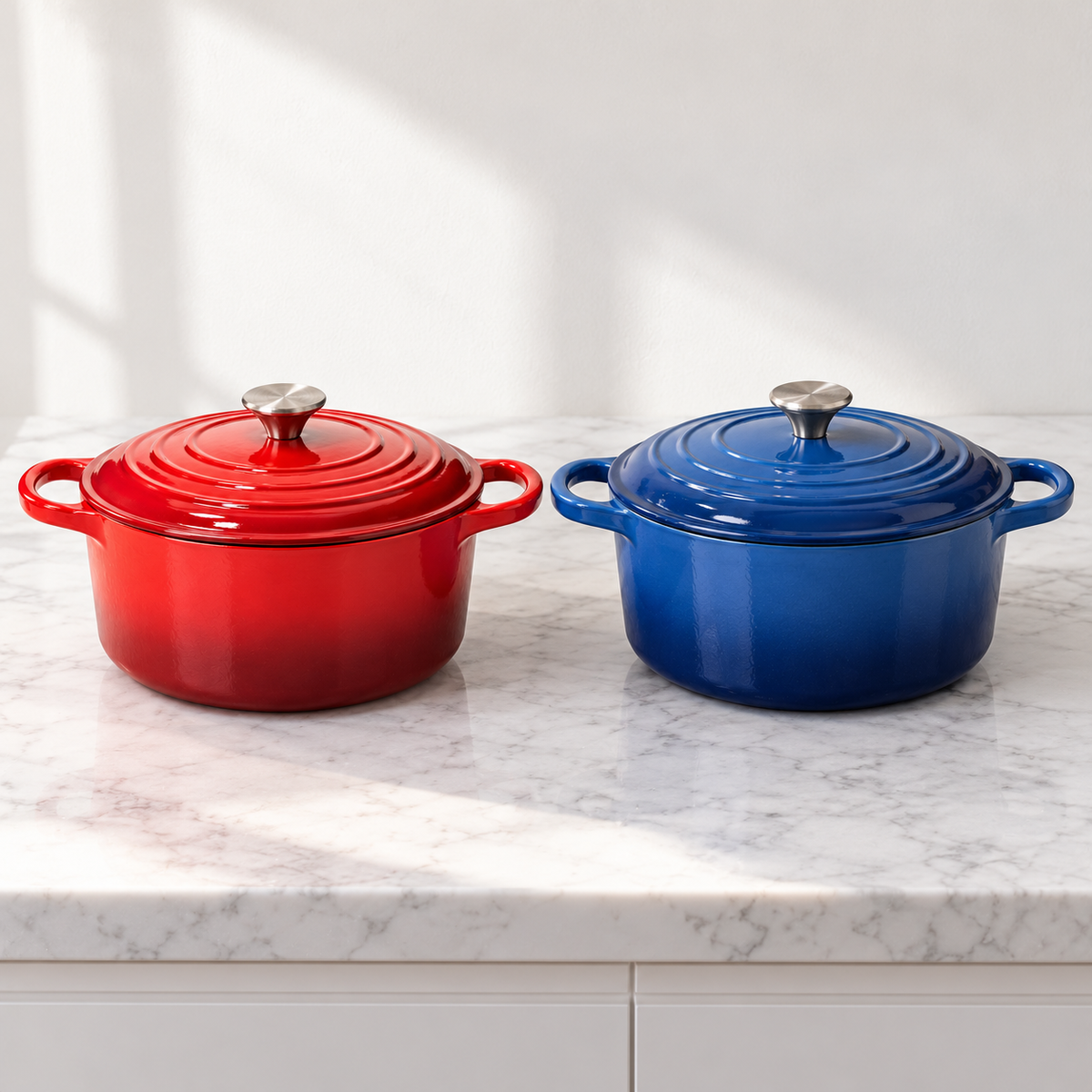Red and blue Dutch ovens side by side on marble