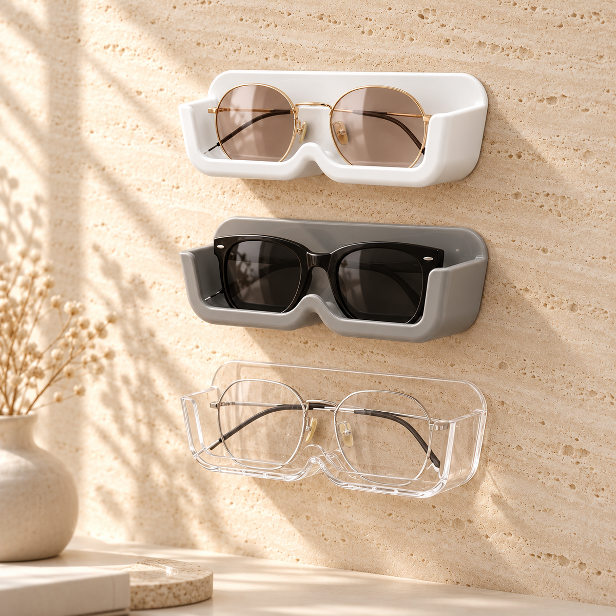 Three wall glasses holders in white, gray and clear stacked on a wall