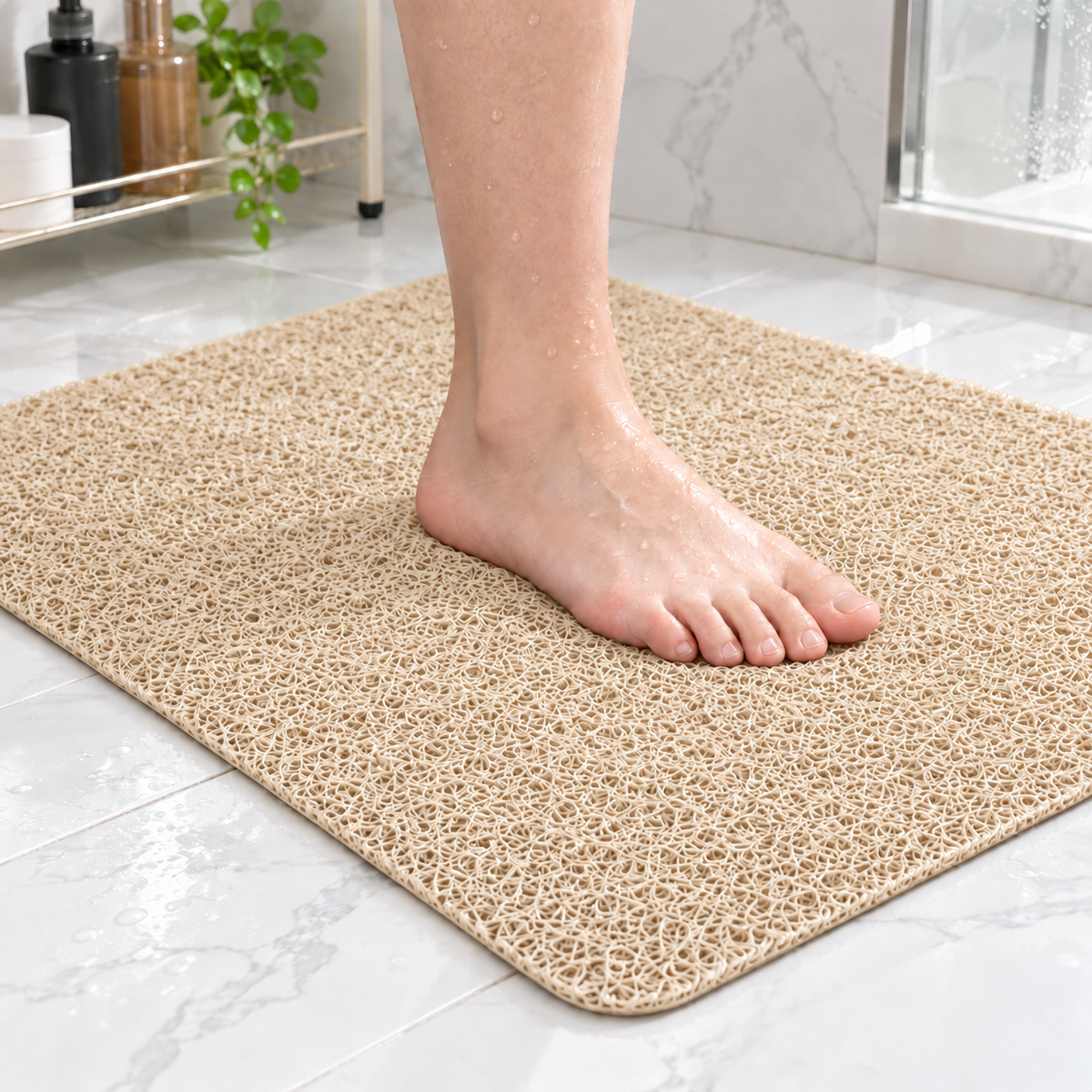 Bare foot standing on a beige loofah shower mat