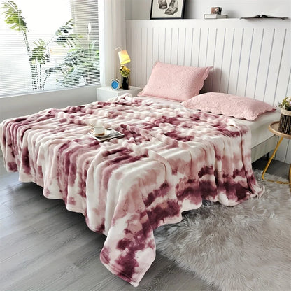 Rose Swirl faux rabbit fur throw on a bed