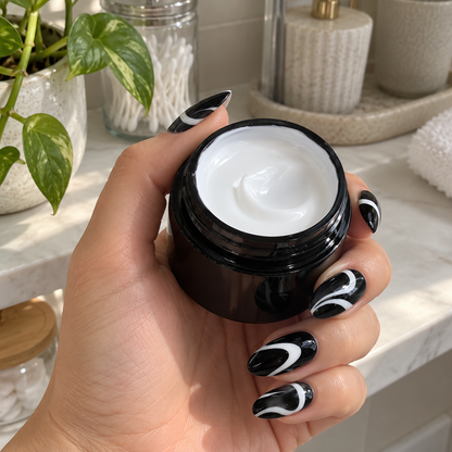 White swirl nail art on black nails with the white painting gel
