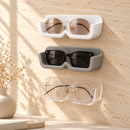 Three wall glasses holders in white, gray and clear stacked on a wall