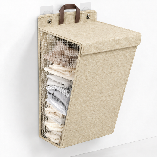 Beige wall-hanging laundry hamper with a lid, mesh side panel and brown handle on adhesive hooks
