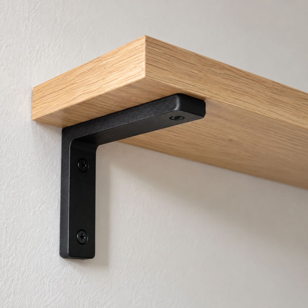 Close-up of a wood shelf board on a black L-bracket